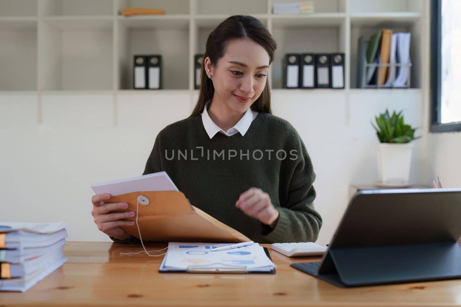 Asian Business woman making prepare presentation or important email of financial. Business Accountant working in home office. by itchaznong