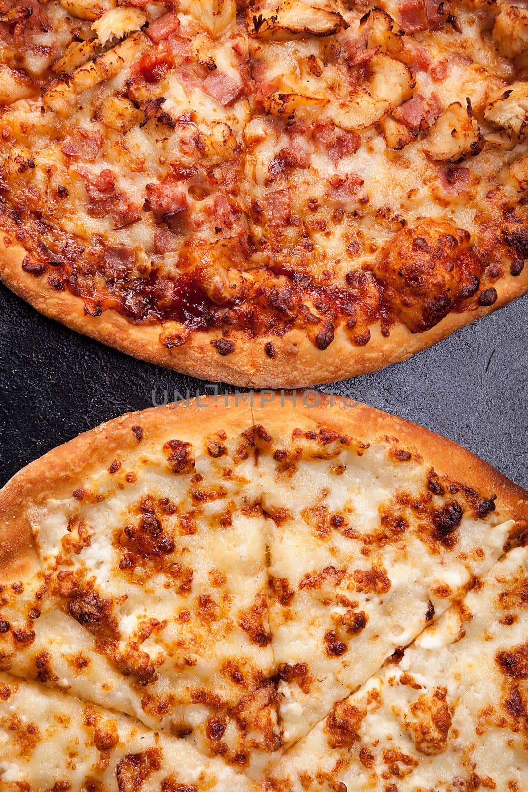 Top view of two pizza lying next to each other by DCStudio