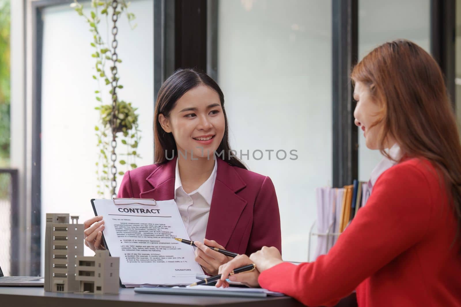 Real Estate Agent explain insurance and agreement contract to client before sign contract. Property insurance and security concept.