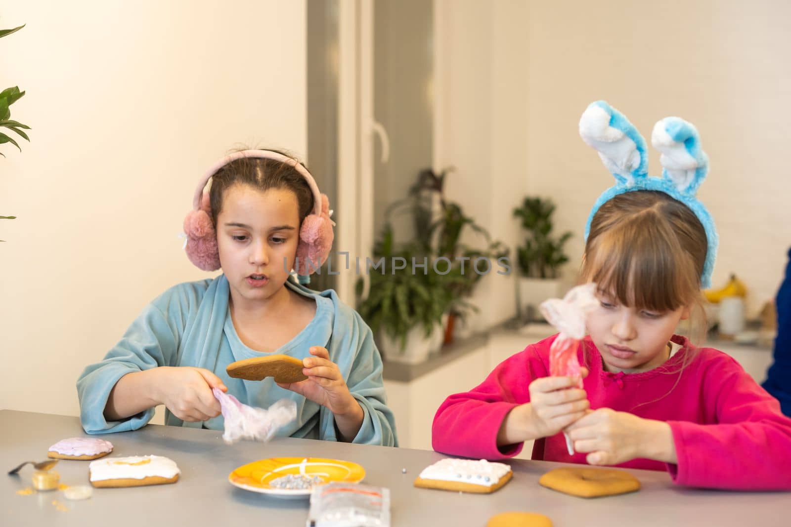 two cute sisters make and decorate cookies by Andelov13