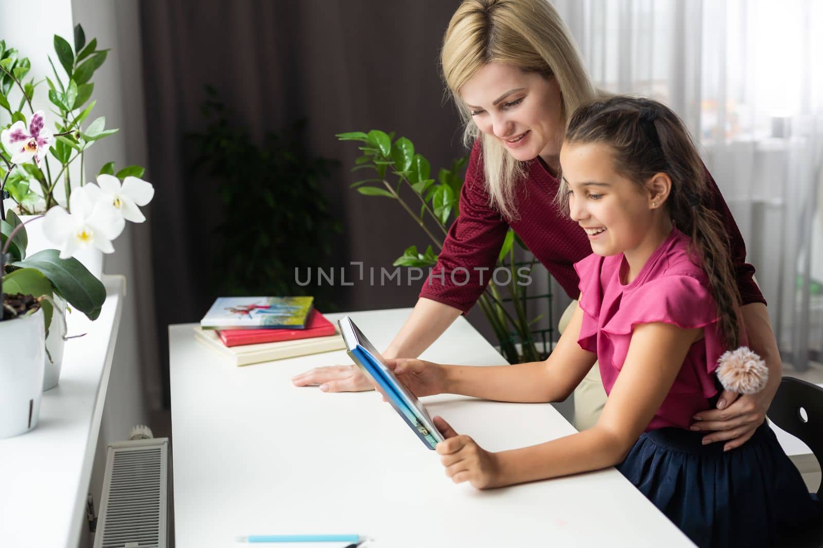 Cute little girl with therapist.Young woman teacher and child on private lesson