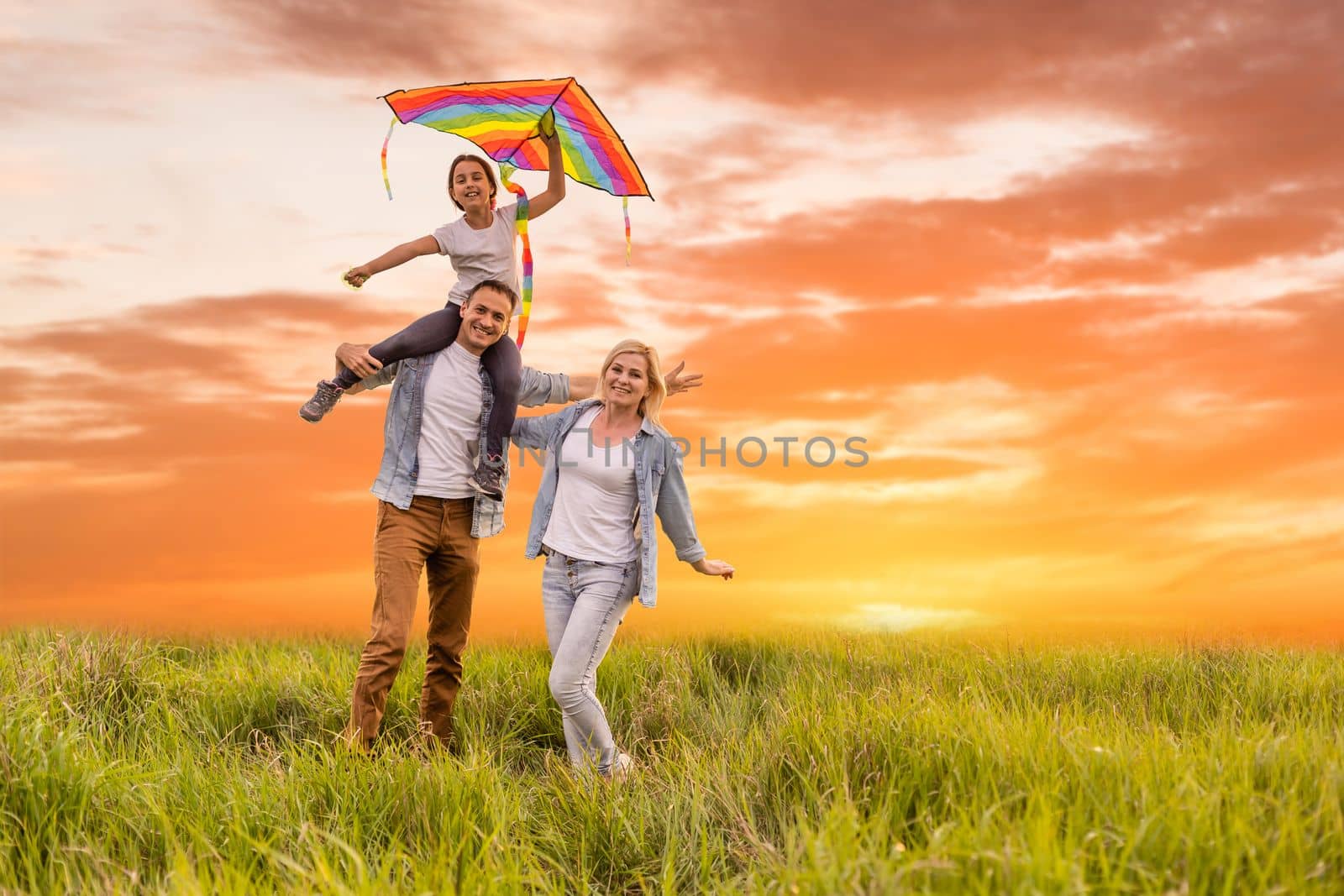 Happy family: mother father and child daughter on nature on sunset.