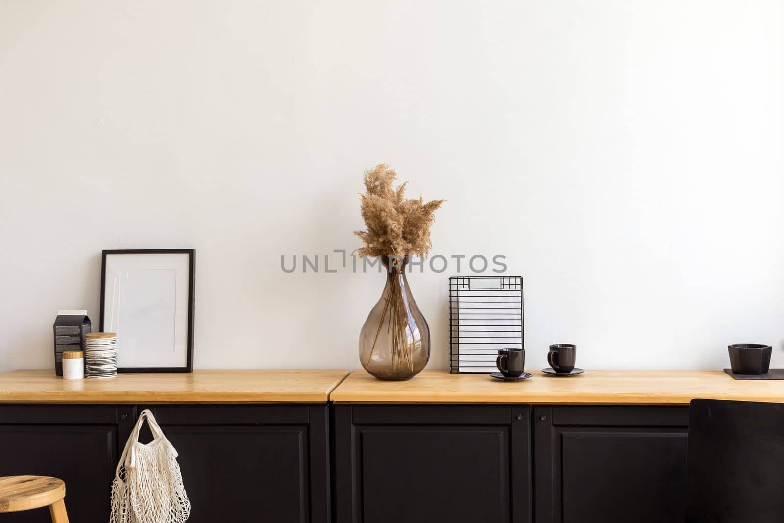 Set of assorted decorations and accessories placed on cupboard against white wall in cozy room at home
