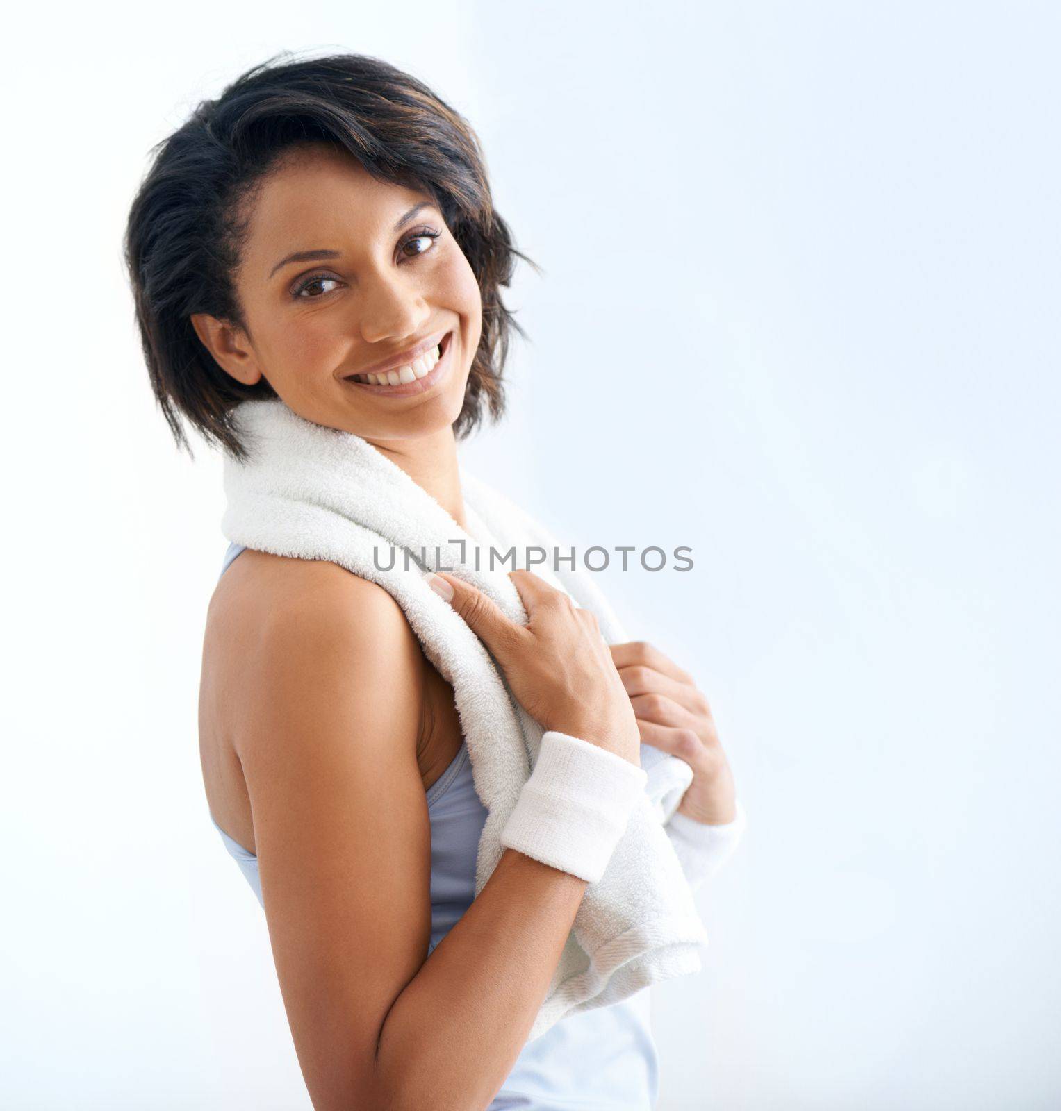 Energised after exercise. Profile of a beautiful young woman with a towel around her neck after a workout