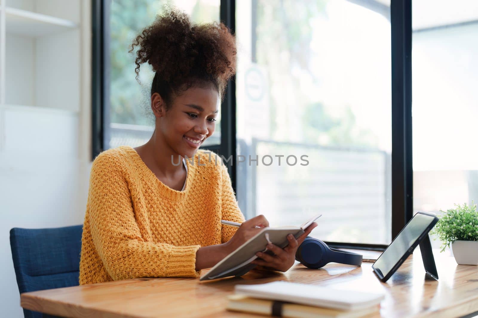 Young black curly hair american african woman using digital tablet by itchaznong