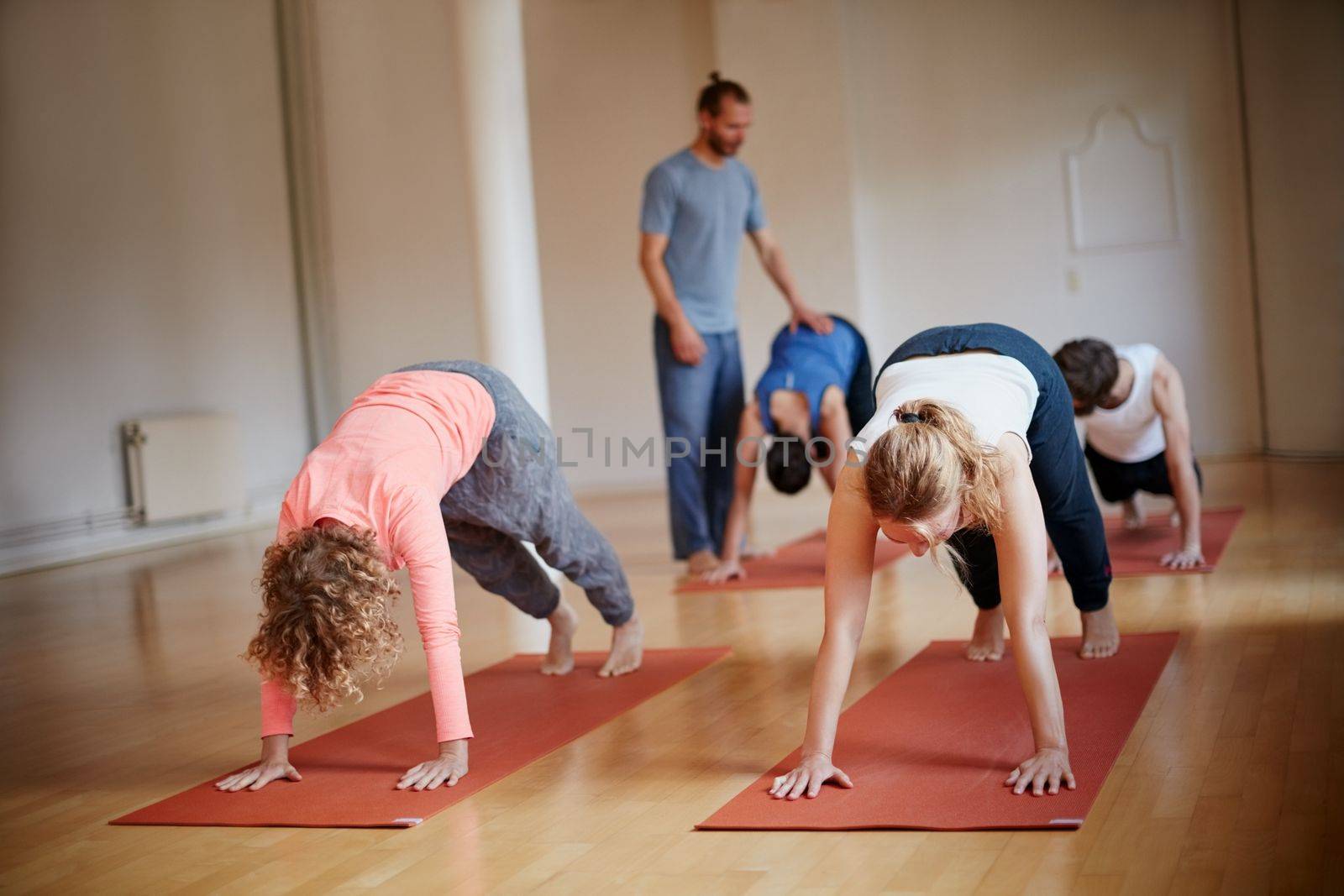 Yoga gets your blood flowing. a group of people attending a yoga class