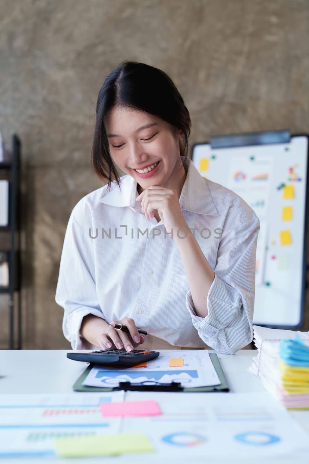 Asian Business woman working at home office and analyze financial report document. Accounting and Finance concept.