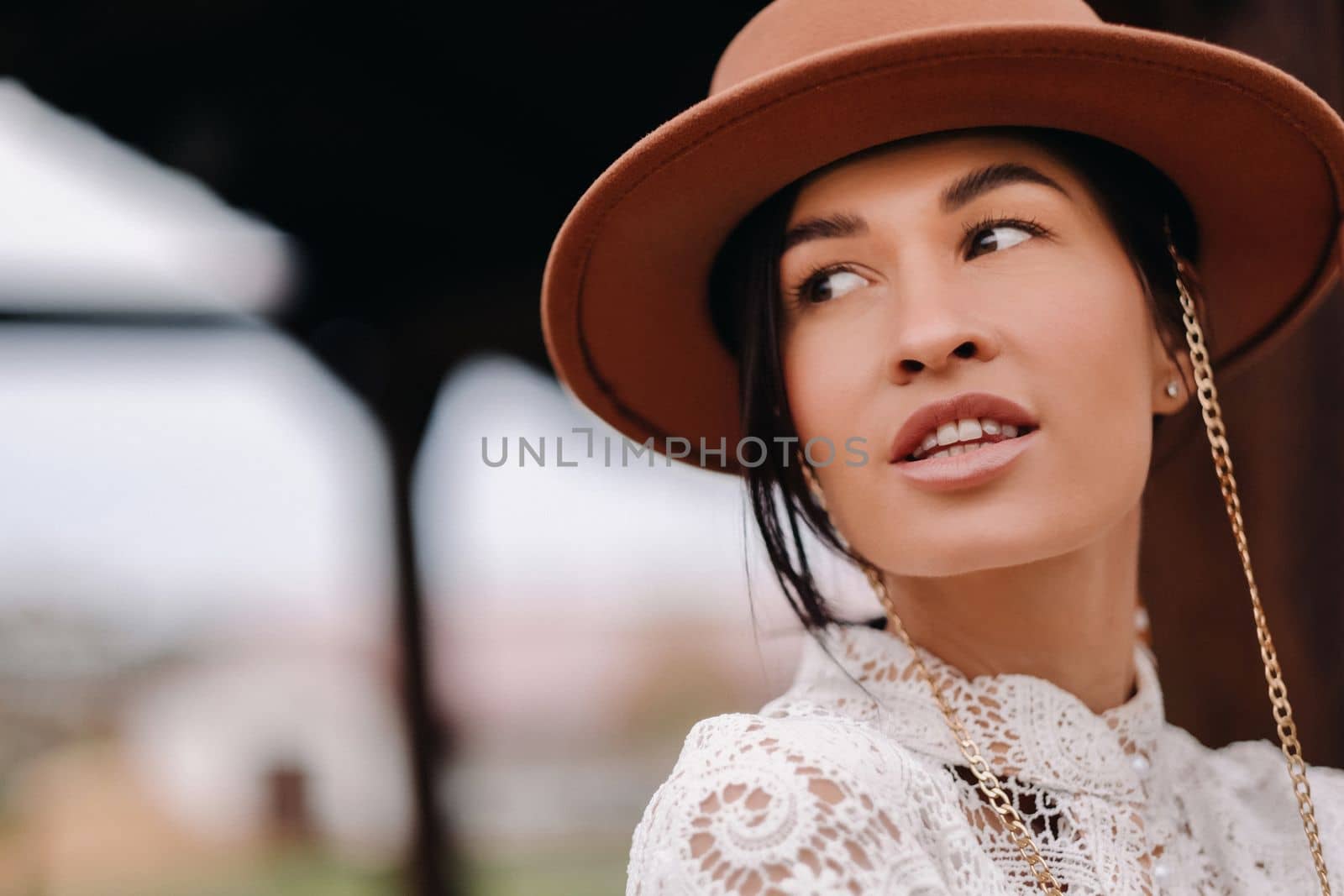 Beautiful girl in vintage lace dress and hat at the ranch.