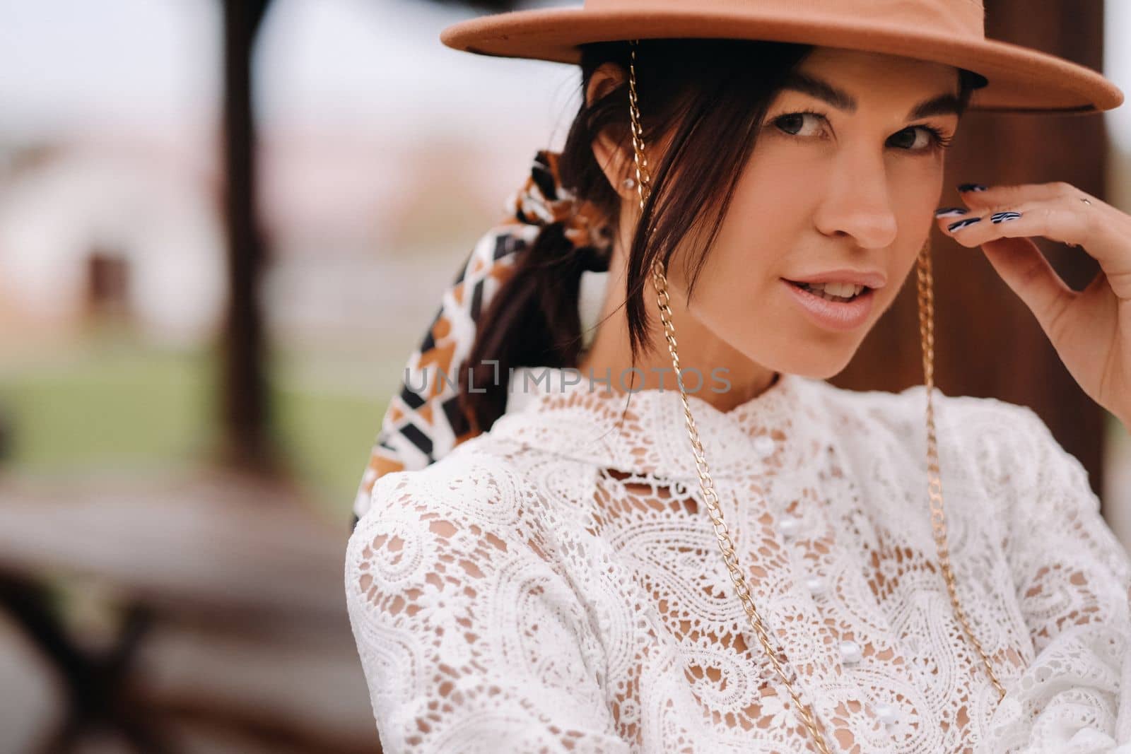 Beautiful girl in vintage lace dress and hat at the ranch.