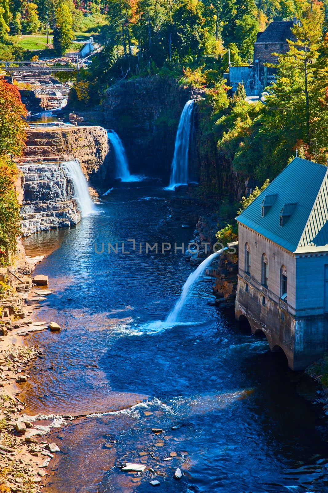 Image of Detail of river canyon with multiple large waterfalls and Hydroelectric power plant