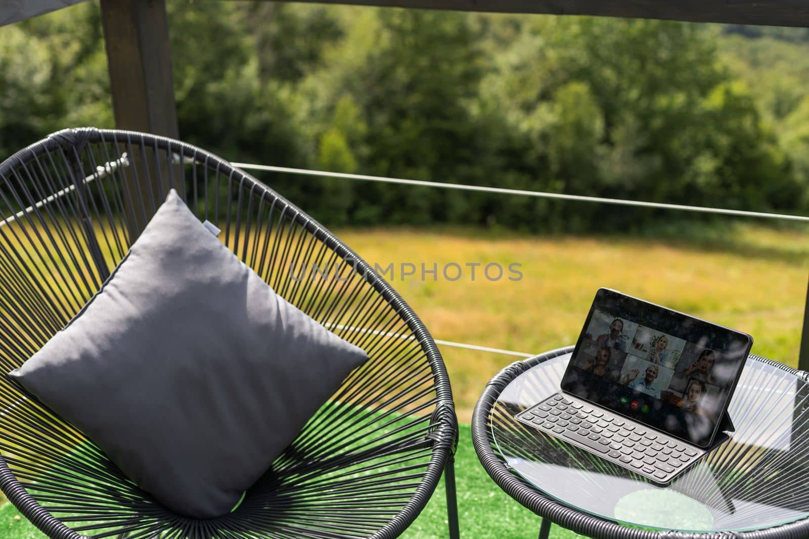 Laptop on wooden terrace, mountains and trees blurred as a background. by Andelov13