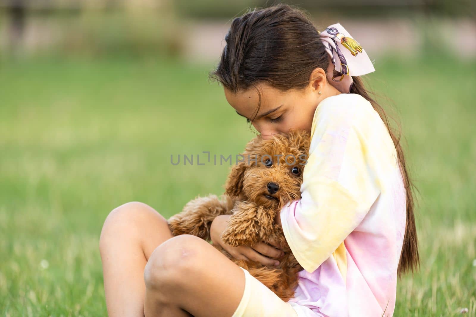 Little girl with a maltese puppy, outdoor summer