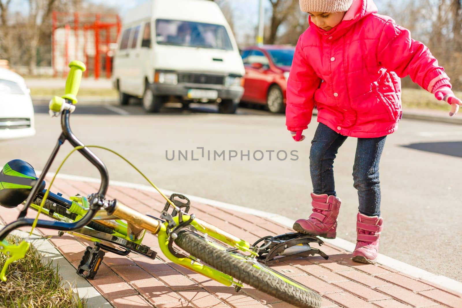 a little girl pumps up a bicycle tire