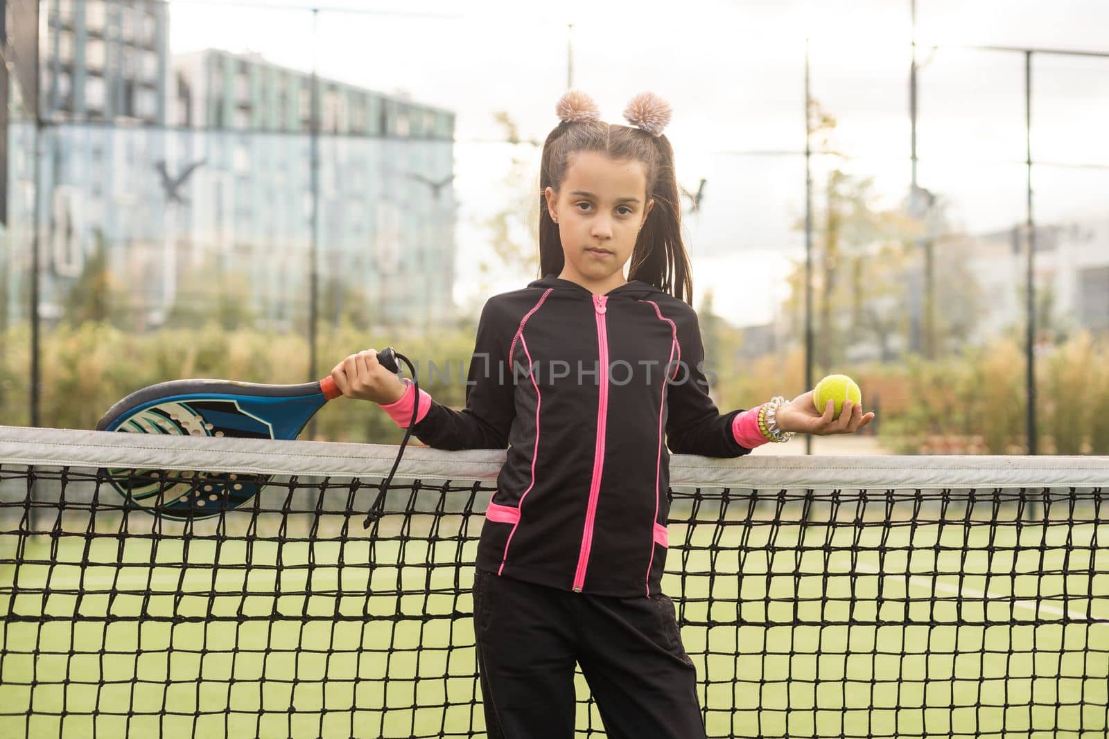 little Girl playing paddle tennis.