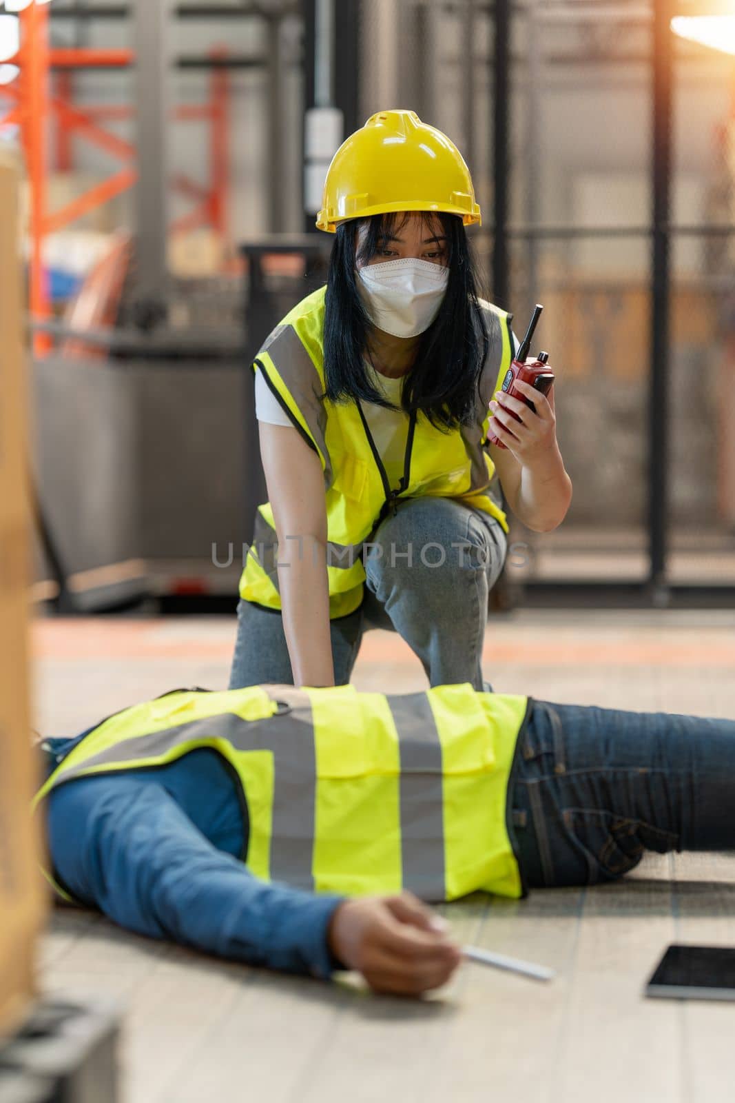 First aid by workmate. Working at warehouse. Male warehouse worker have accident. by itchaznong