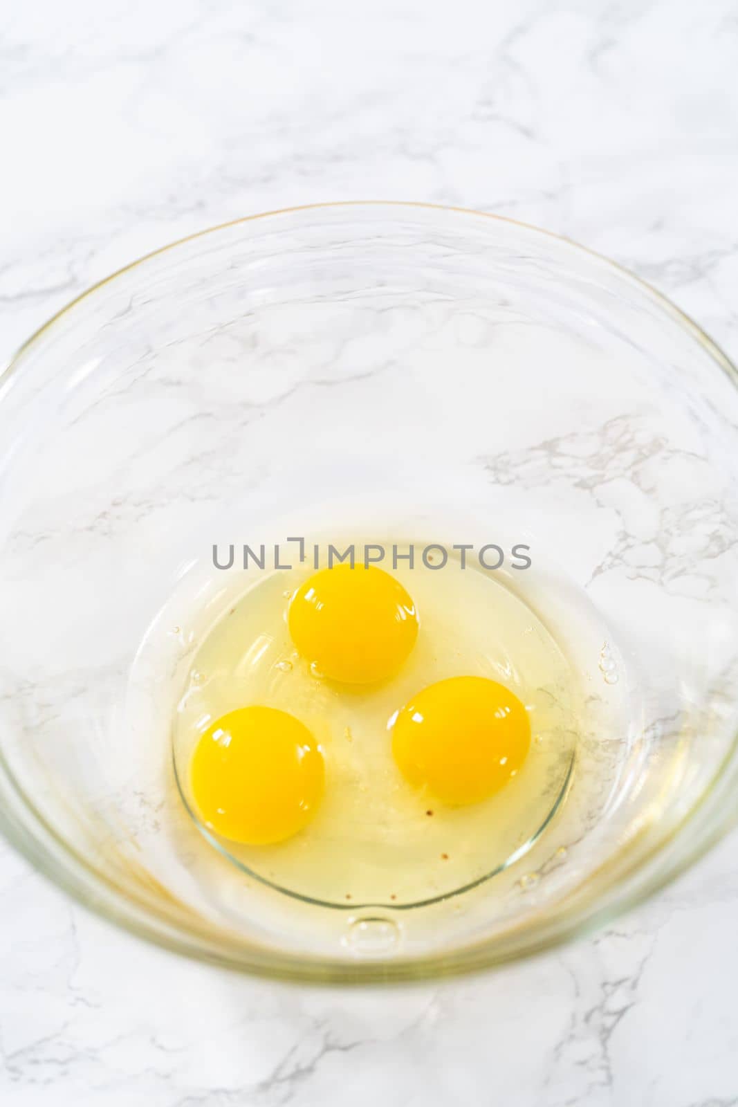 Measured ingredients in glass mixing bowls to bake American flag mini cupcakes.