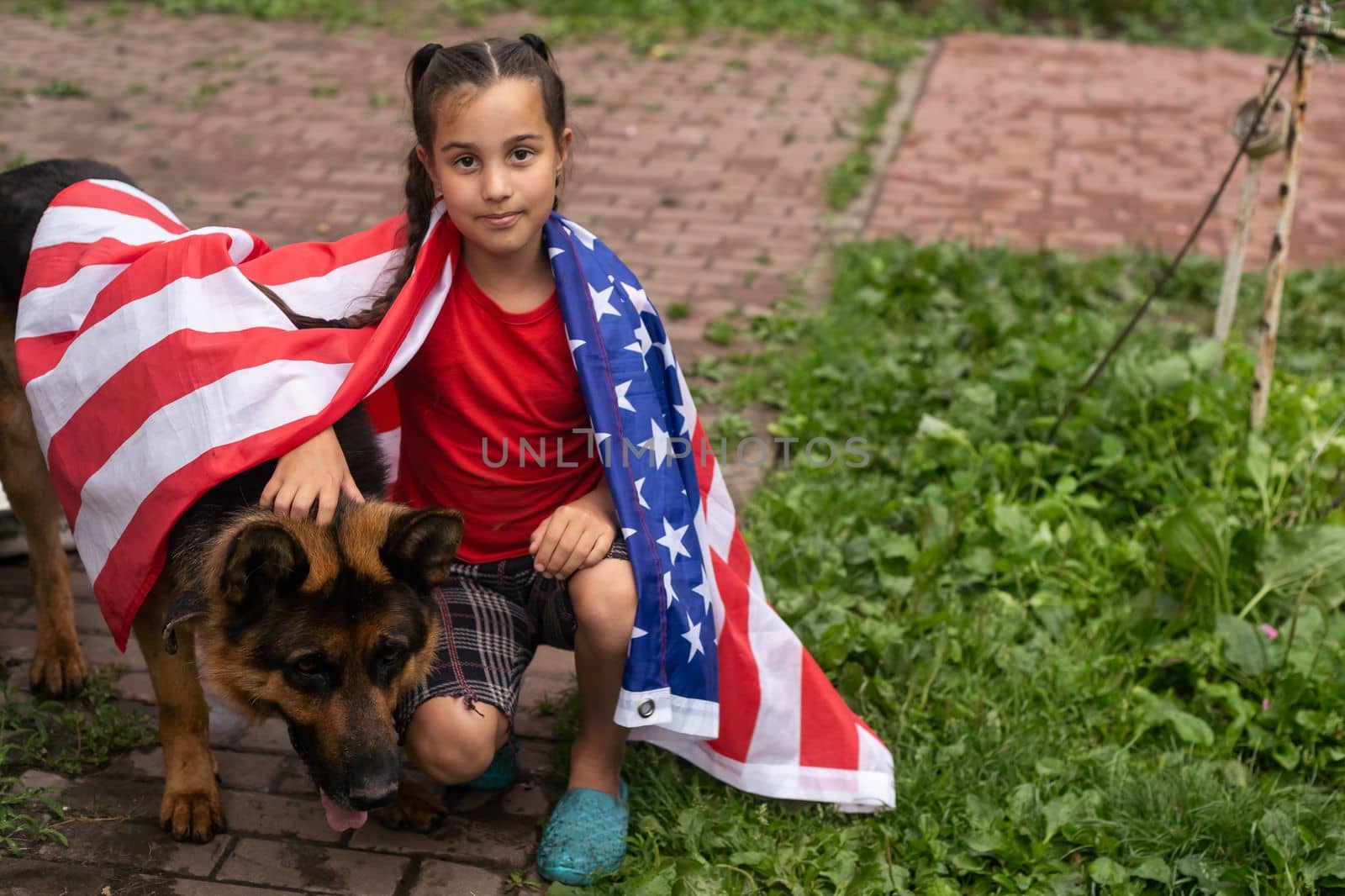 Happy adorable little girl smiling and waving American flag outside, her dress with strip and stars, cowboy hat. Smiling child celebrating 4th july - Independence Day by Andelov13