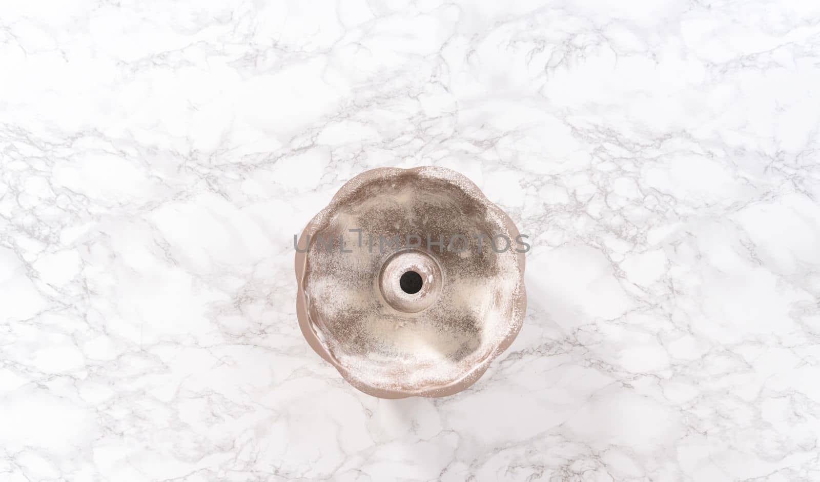 Flat lay. Greasing bunt cake pan to bake chocolate pumpkin bundt cake with toffee glaze.