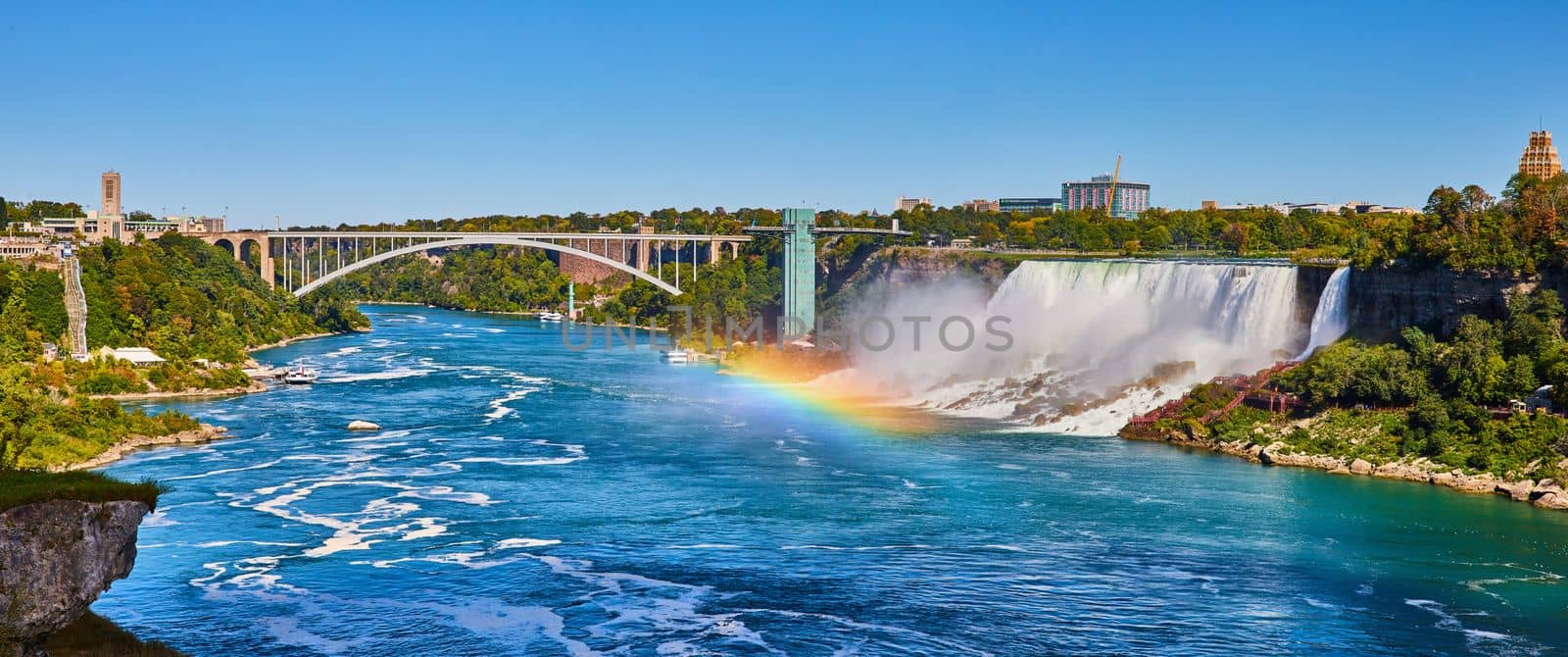Stunning rainbow over Niagara River looking at American Falls and Rainbow Bridge by njproductions