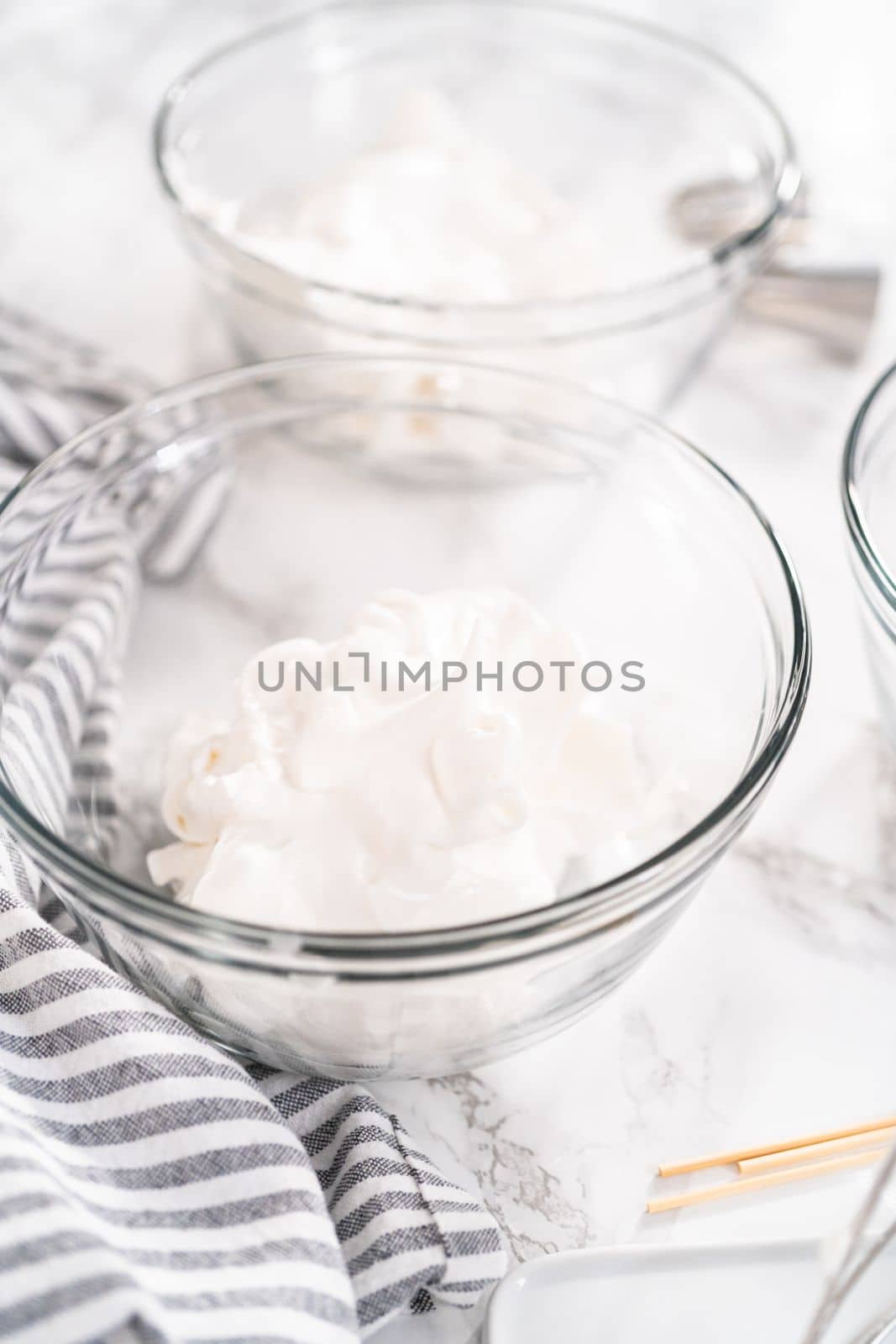 Making meringue in kitchen mixer to bake unicorn meringue cookies.