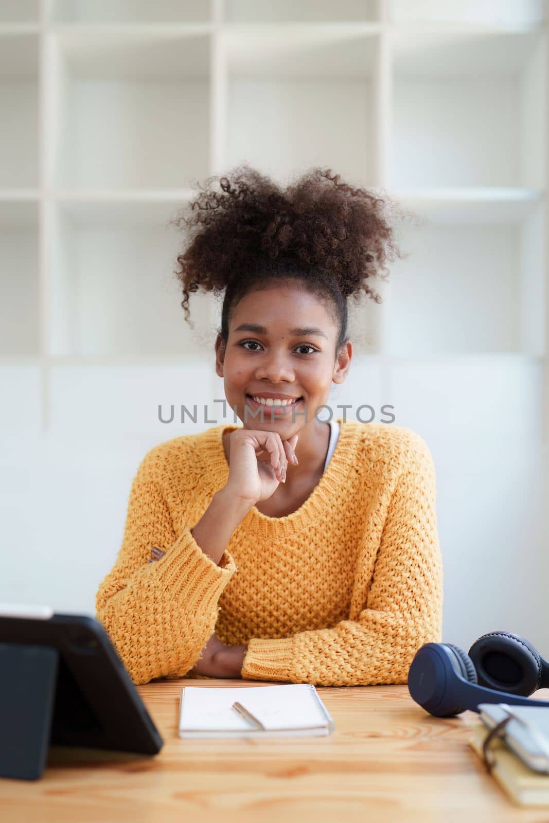 Young black curly hair american african woman using digital tablet.