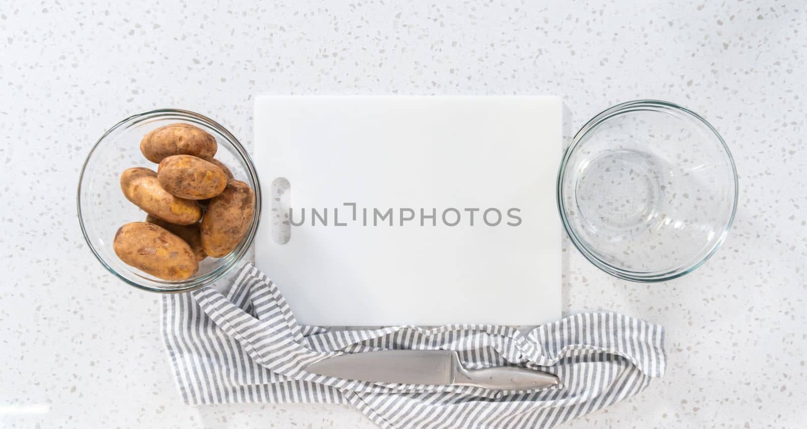 Flat lay. Peeling and cutting Russet potatoes to make potato salad.
