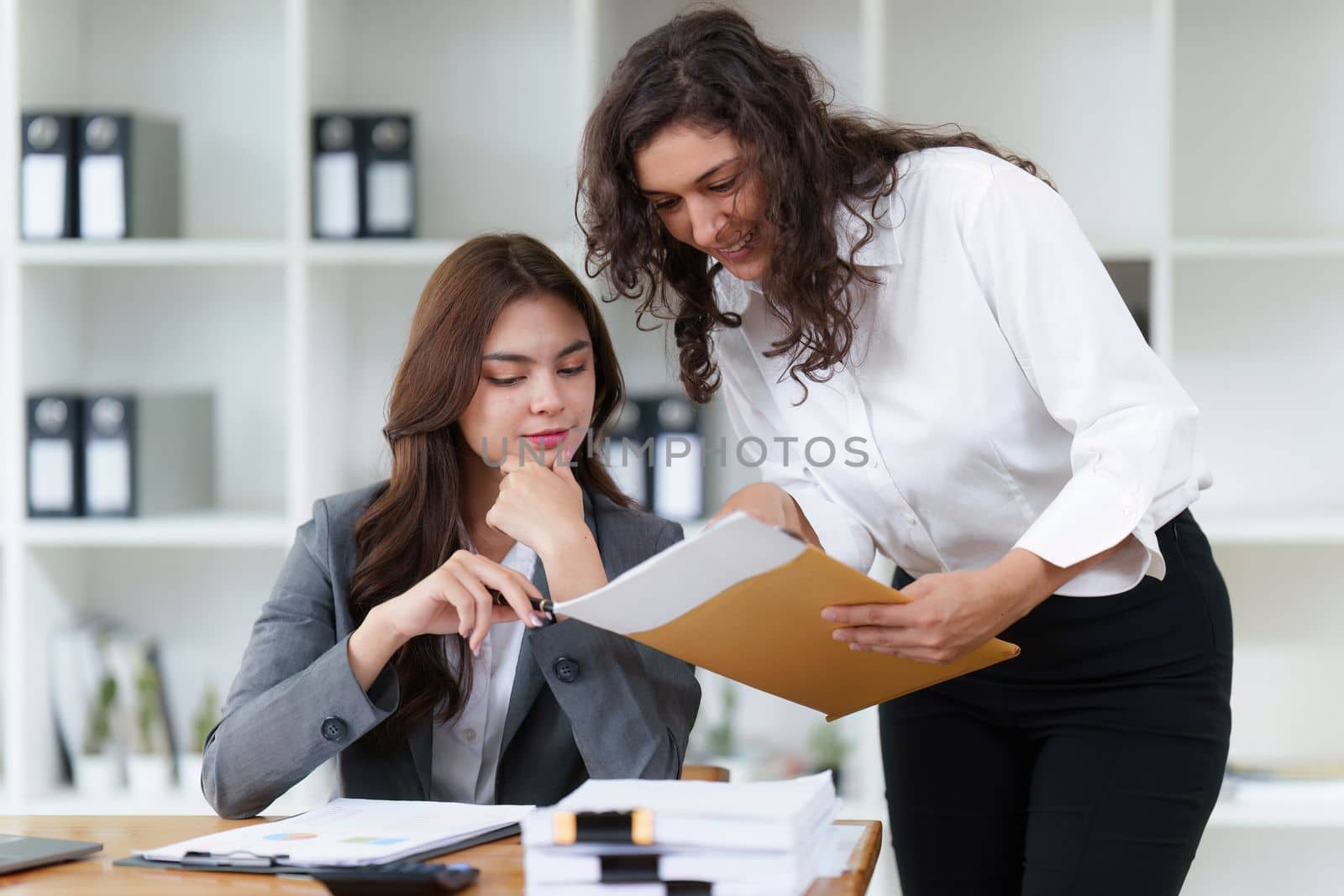Business People Meeting to discuss and brainstorming the financial report paperwork in home office. Financial advisor teamwork and accounting concept.