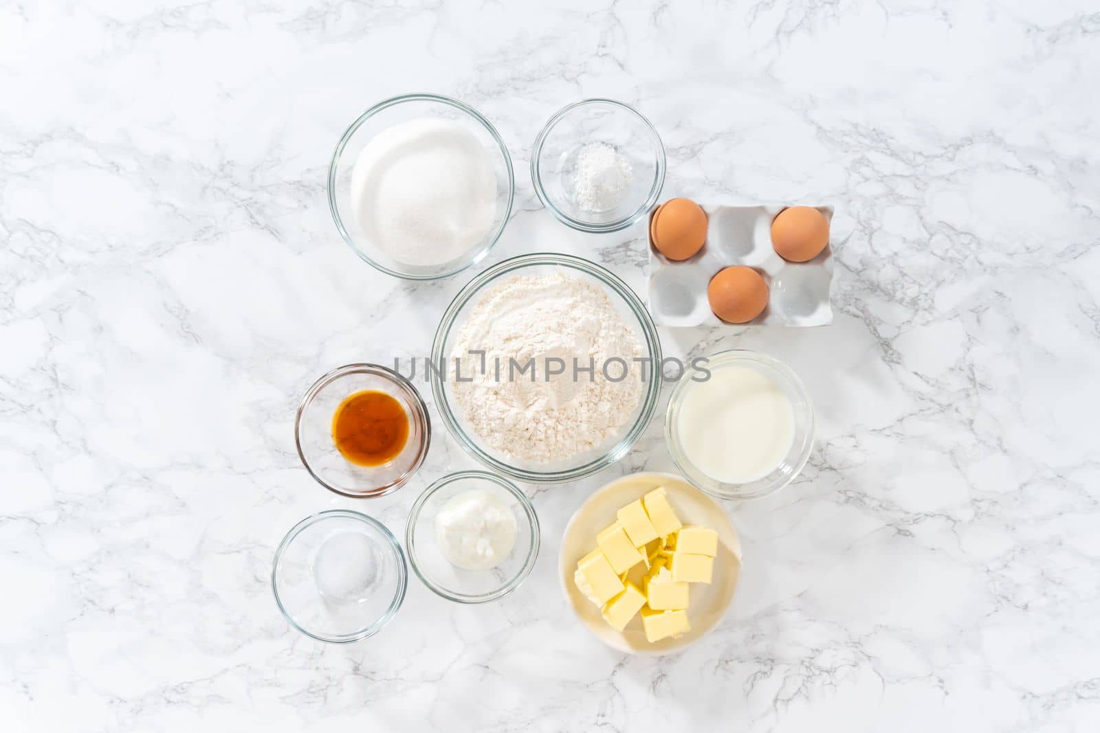 Flat lay. Measured ingredients in glass mixing bowls to bake American flag mini cupcakes.