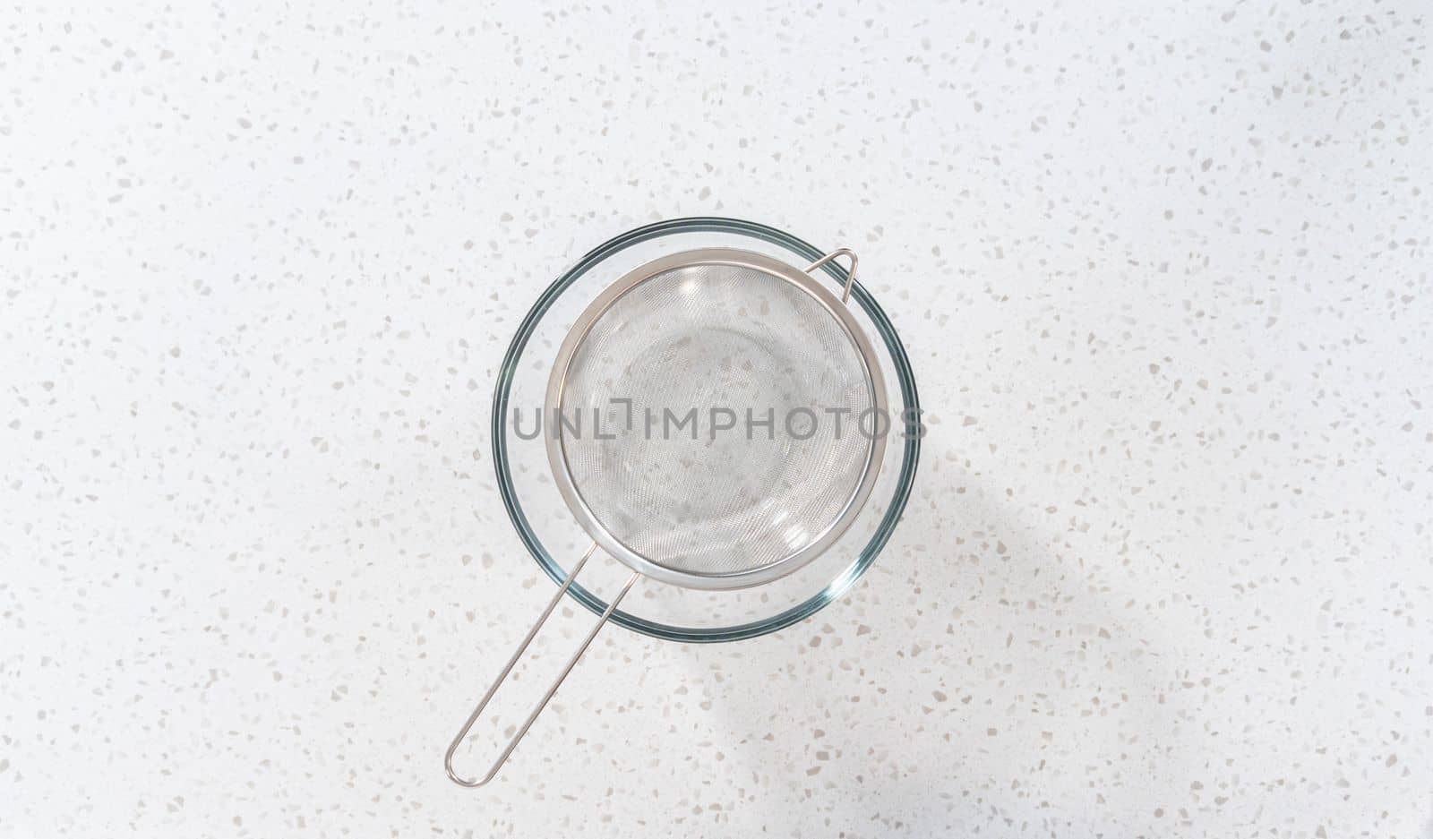 Flay lay. Draining browned ground turkey through a fine mesh strainer.
