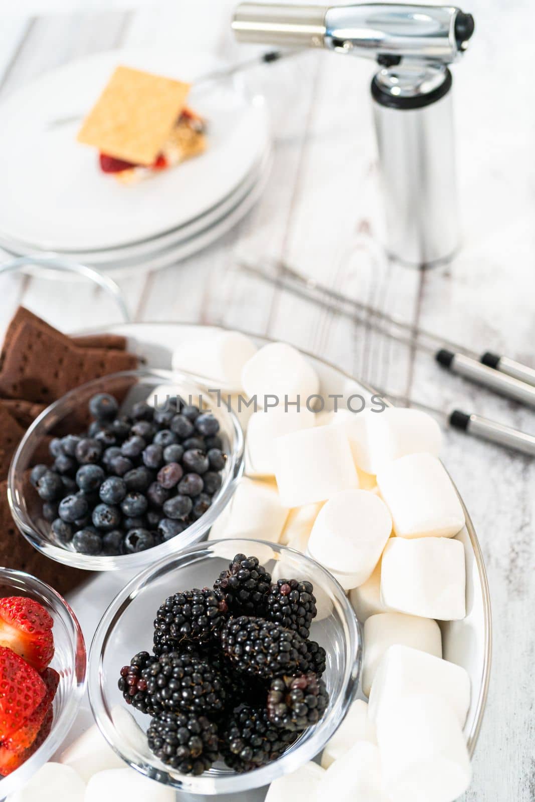 Making s'mores on a homemade star-shaped chocolate graham cracker with toasted marshmallow and fruits.