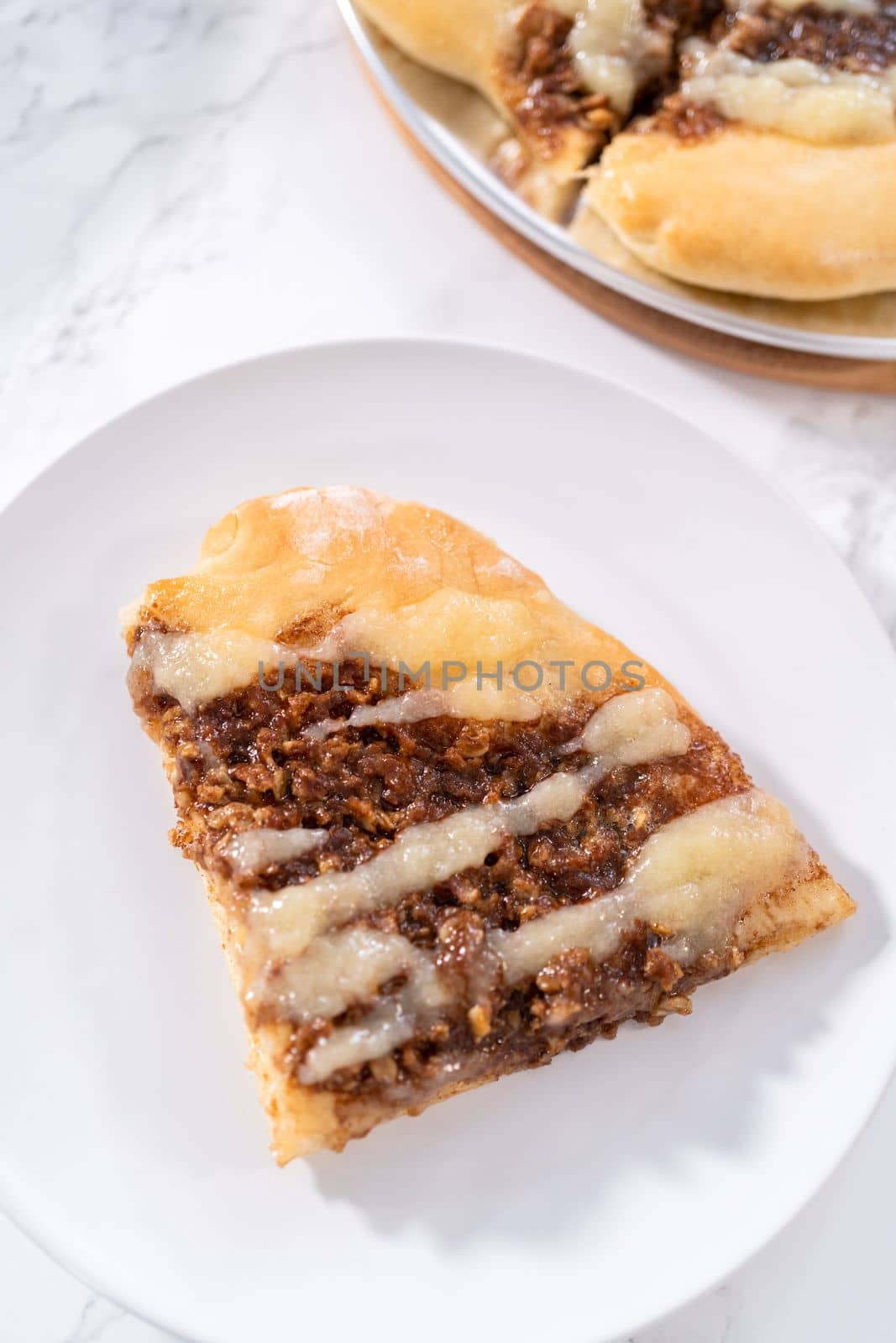 Freshly baked cinnamon dessert pizza with cream cheese drizzle.