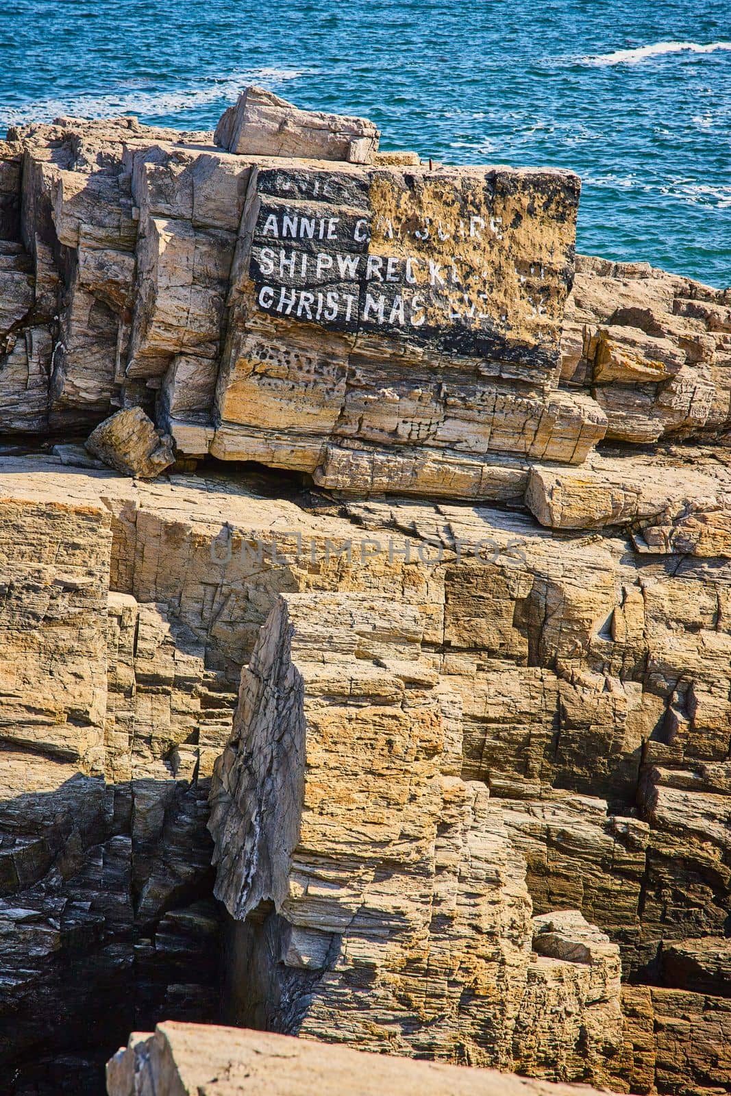 Image of Annie C. Maguire shipwreck marker on Maine coastline
