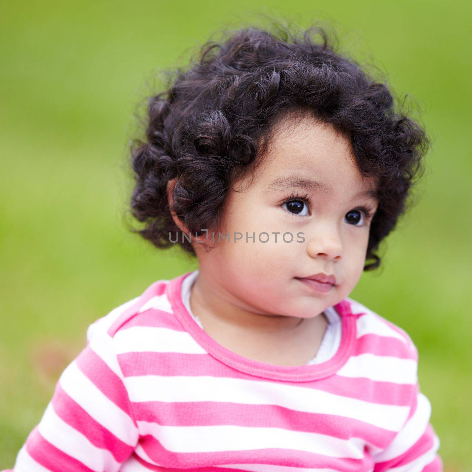 Shes a cutie. Adorable little girl looking thoughtfully away
