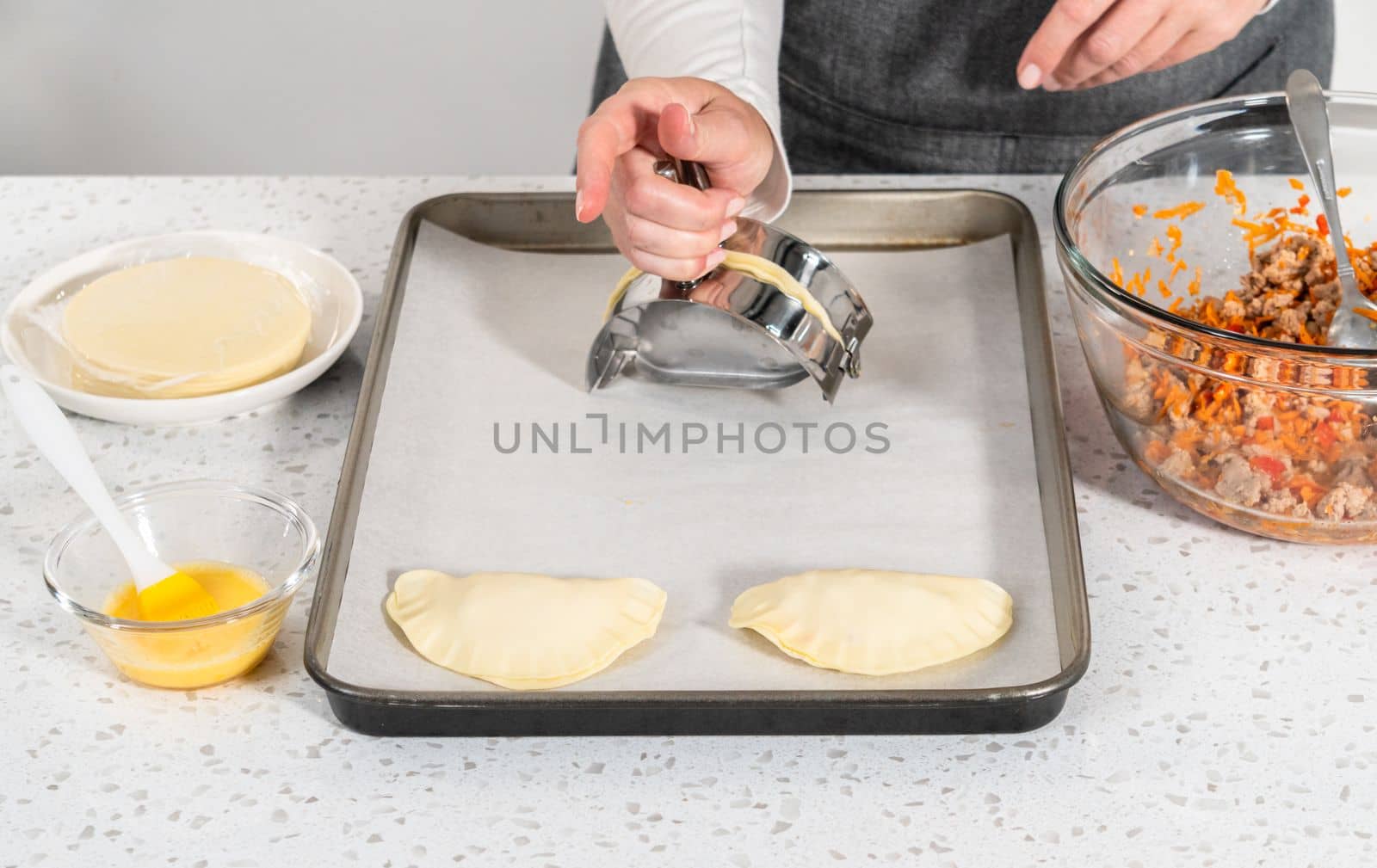 Flat lay. Filling empanada dough with turkey filling to make turkey empanadas.