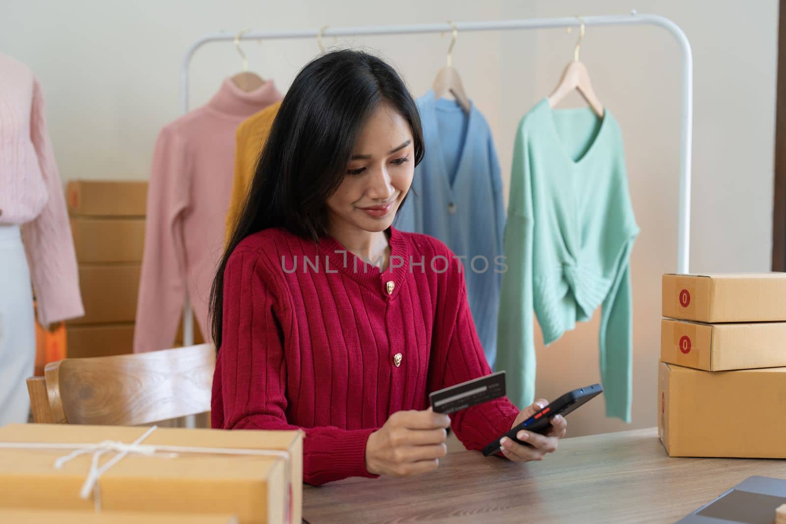 Young person using credit card and laptop computer. Online shopping, e-commerce concept.
