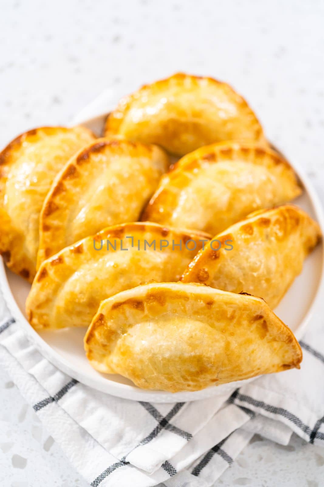 Freshly baked turkey empanadas on the kitchen counter.