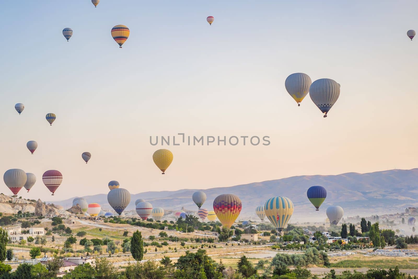 Colorful hot air balloon flying over Cappadocia, Turkey by galitskaya