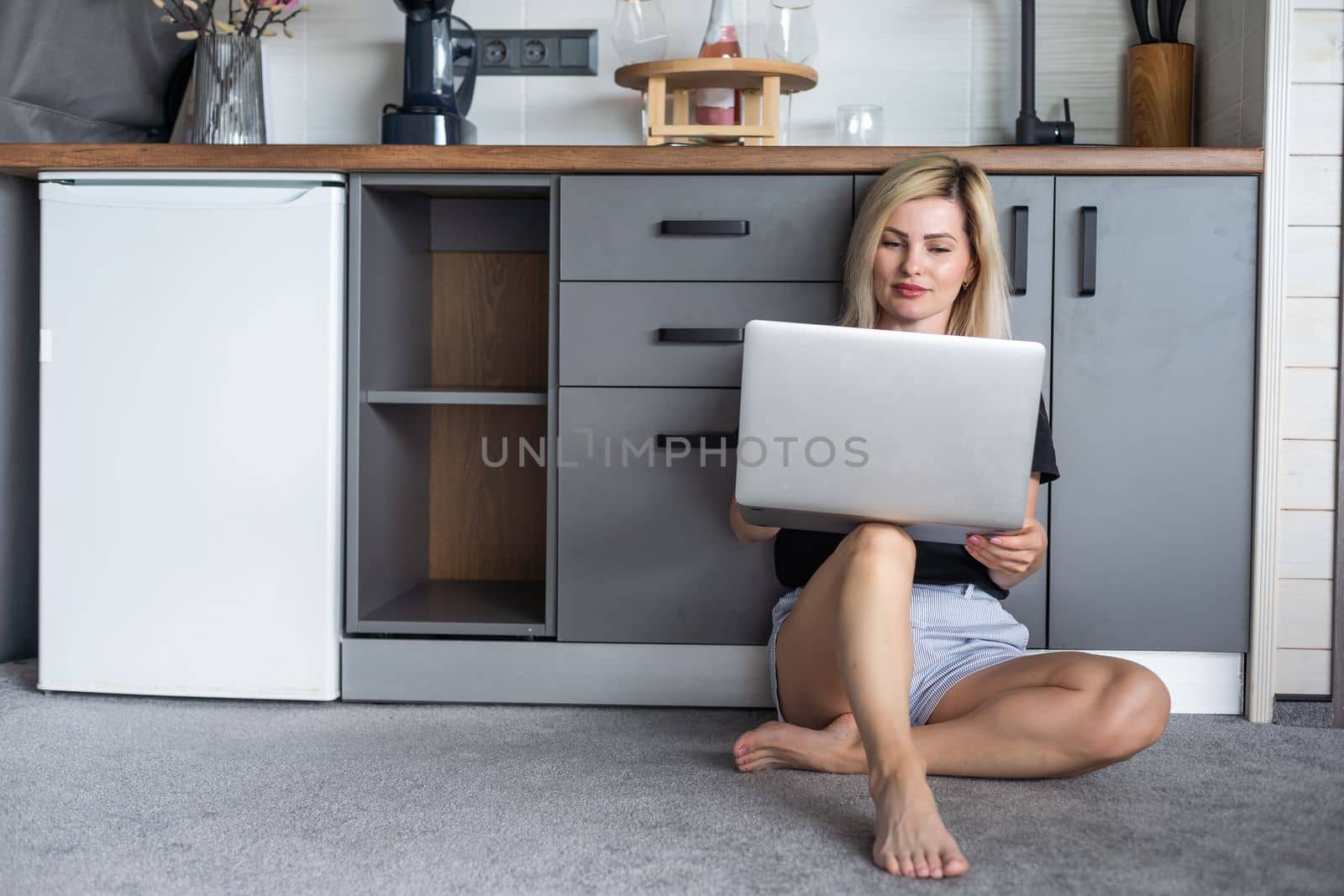 Image of young pleased happy cheerful cute beautiful business woman using laptop computer listening.