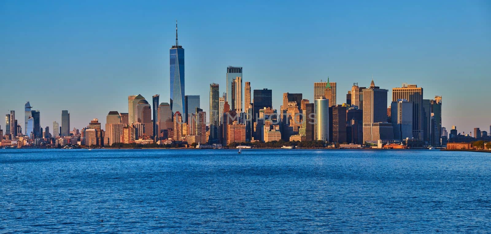 New York City southern Manhattan panoramic skyline near sunset golden hour dusk from bay with One World Observatory by njproductions