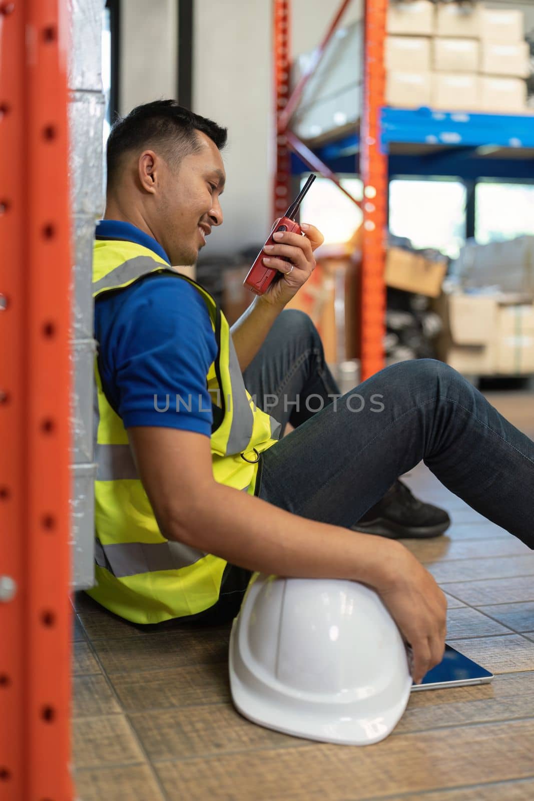 Working at warehouse. Male warehouse worker checking in storage department. Employee organizing goods distribution to the market