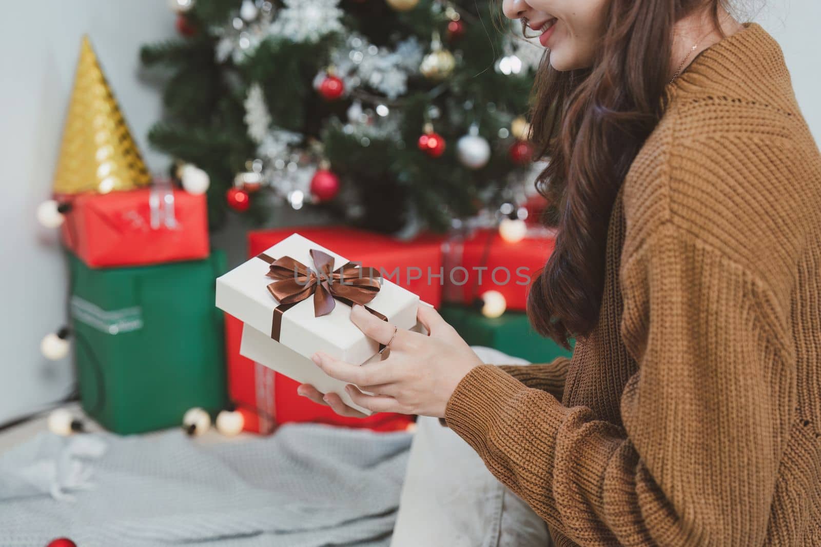 Cheerful lady surprised of the present after the opening in the gift box. Marry Christmas and Happy Holidays and New Year eve celebrating concept by itchaznong