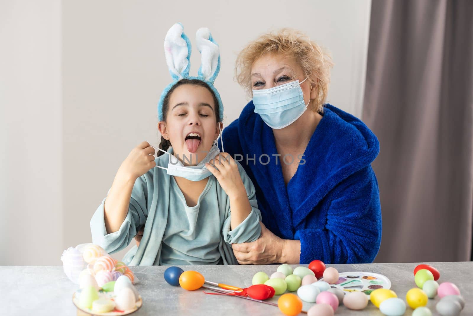 grandmother and granddaughter in masks for easter by Andelov13