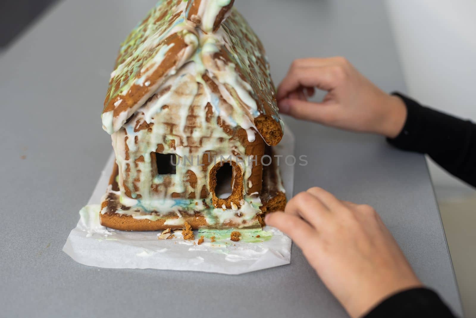 Kids with gingerbread house, A teenage girl is eating a gingerbread house by Andelov13