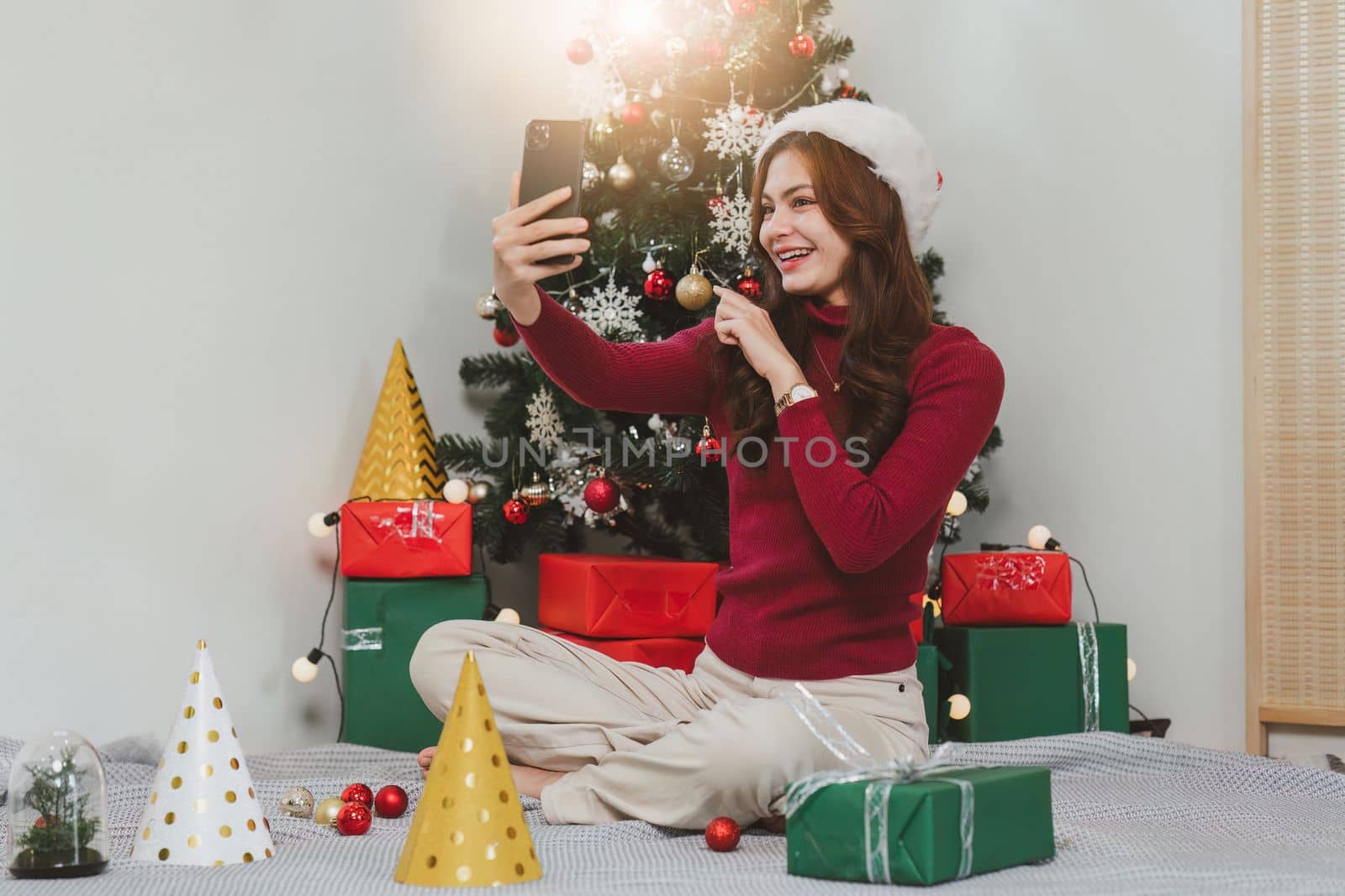 Cheerful lady surprised of the present after the opening in the gift box. Marry Christmas and Happy Holidays and New Year eve celebrating concept.