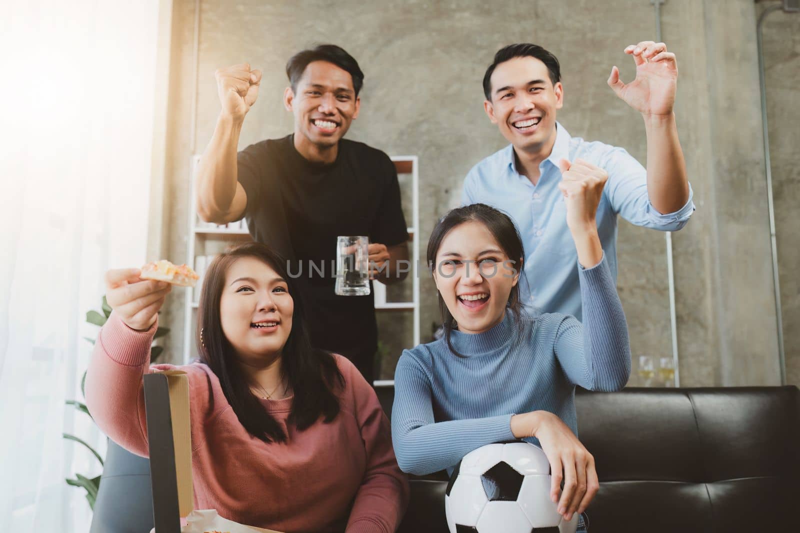 Excited friends having fun by watching football or soccer match and eating pizza at home. Friendship, leasure, rest, home party football, Soccer concept.