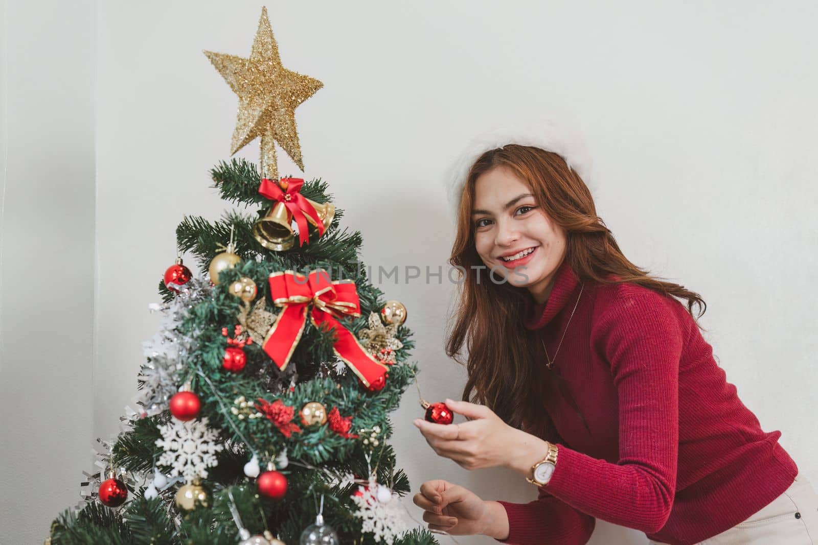 Cheerful lady surprised of the present after the opening in the gift box. Marry Christmas and Happy Holidays and New Year eve celebrating concept by itchaznong
