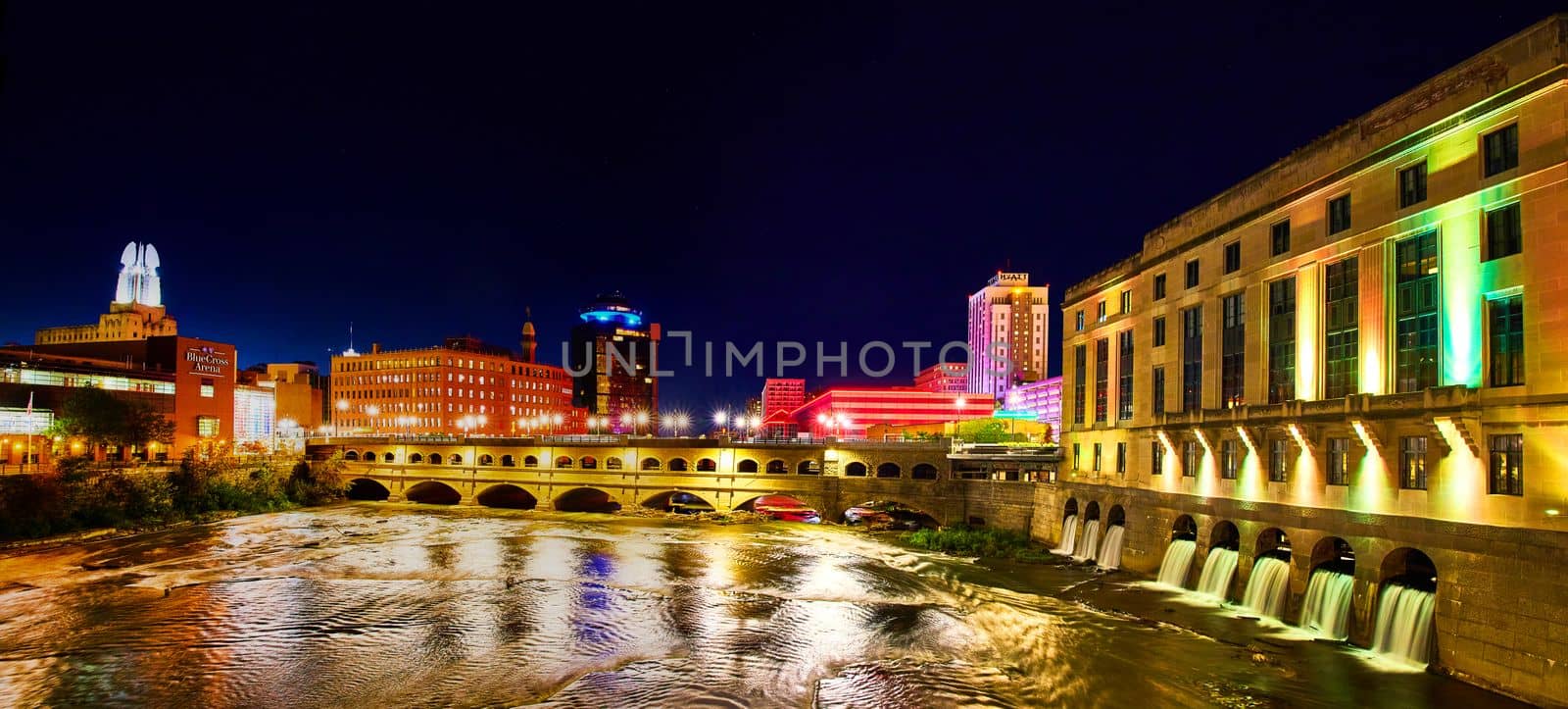 Image of Manmade waterfalls and river in Rochester New York at night with city lights
