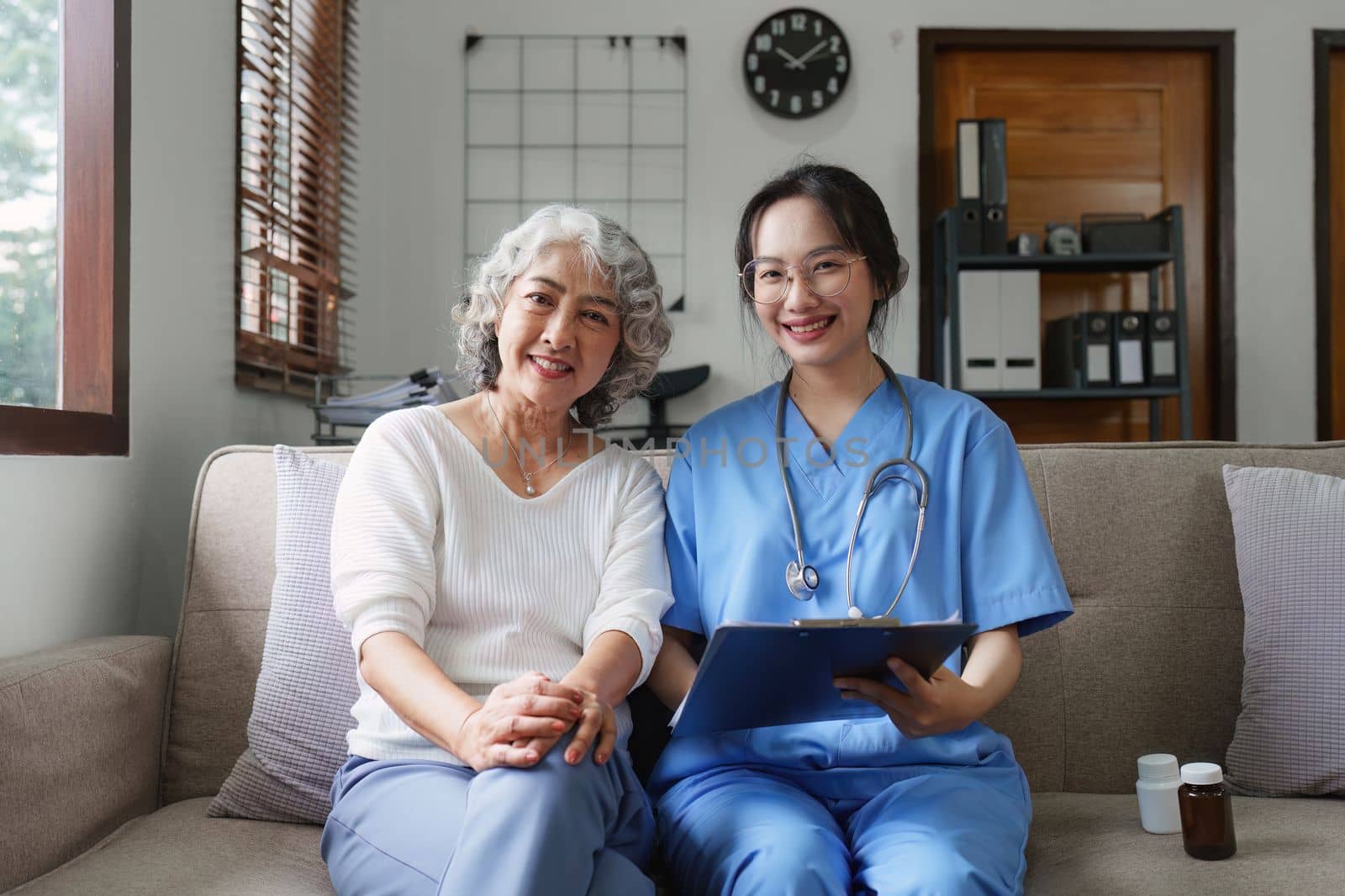 Asian youthful nurse caring for patients or the elderly at home. nursing at home concept.