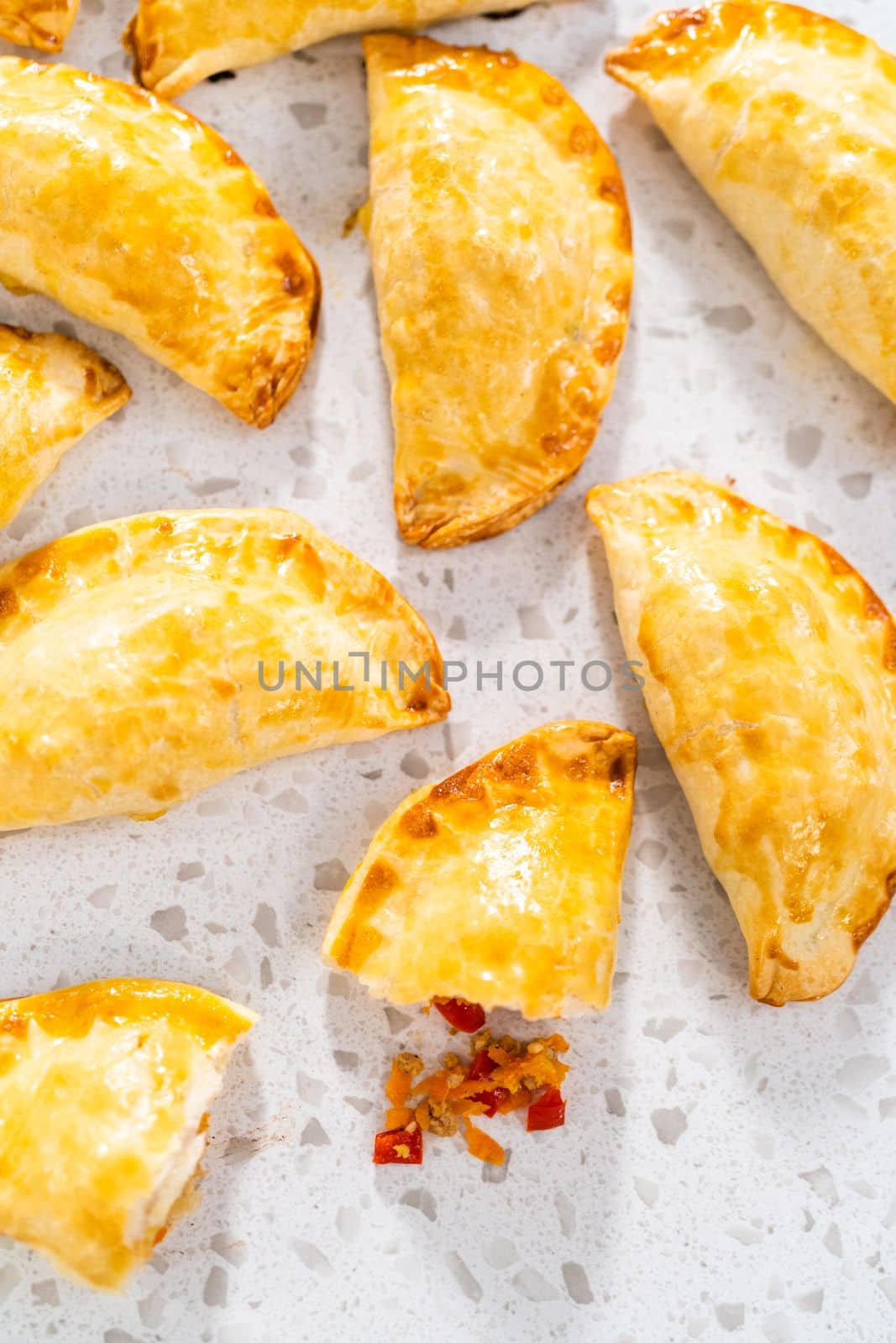 Freshly baked turkey empanadas on the kitchen counter.