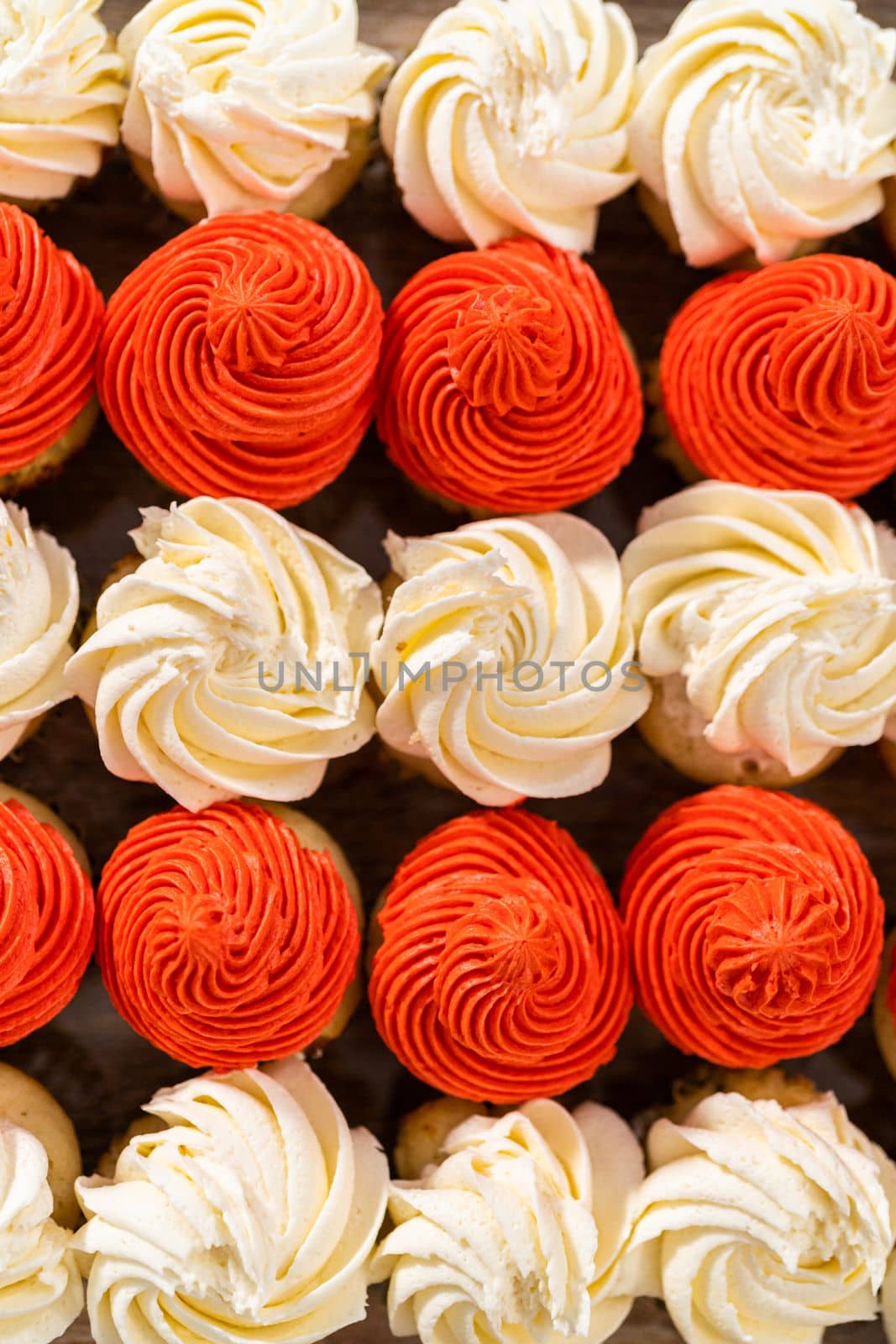 Arranging mini vanilla cupcakes in the shape of the American flag.